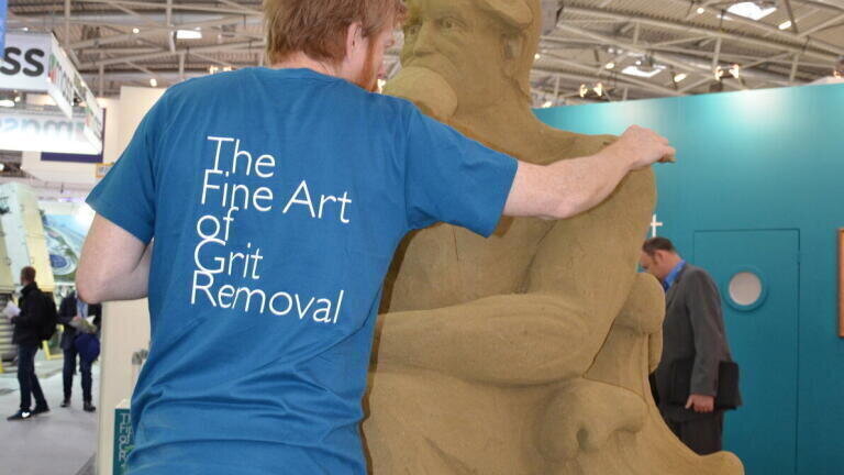 Sculptor Niall Andrew Magee painstakingly crafts the sculpture from find sand. 