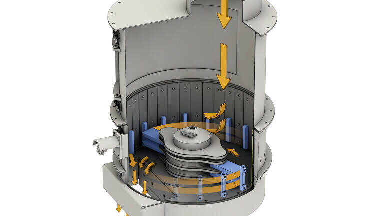 Inside the machine is a rapidly turning, star-shaped rotor with a vertical shaft and massive crushing tools.